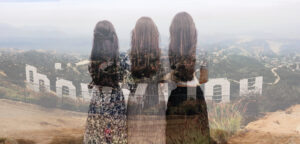 Three women in dresses with long brown hair stand side by side with their backs to the camera. Superimposed over them is a photo taken from the hilltop behind the infamous white HOLLYWOOD sign in California.